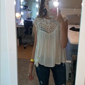 A cream sleeveless top